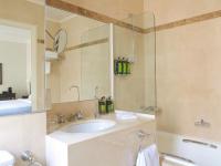 a bathroom with a sink and a mirror at Hotel Royal Saint Honore Paris Louvre in Paris