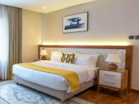 a bedroom with a large bed and a window at Deerpark Luxury Stays in Nairobi