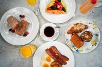 a table with plates of breakfast foods and a cup of coffee at Waldorf Astoria Chicago in Chicago