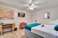 a bedroom with a bed and a desk and a ceiling fan at Santa Monica Hotel in Los Angeles