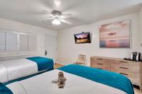 a bedroom with two beds and a dog sitting on the bed at Santa Monica Hotel in Los Angeles