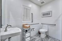a white bathroom with a toilet and a sink at Santa Monica Hotel in Los Angeles