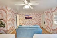 a room with a ceiling fan and a blue bed at Santa Monica Hotel in Los Angeles