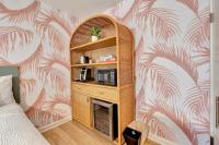 a room with a book shelf with a microwave in it at Santa Monica Hotel in Los Angeles