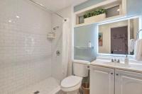 a white bathroom with a toilet and a sink at Santa Monica Hotel in Los Angeles