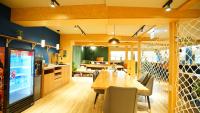 a kitchen and dining room with a table and chairs at RF Hotel - Zhongxiao in Taipei