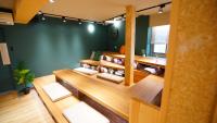 a room with wooden tables and chairs and a green wall at RF Hotel - Zhongxiao in Taipei