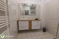 a bathroom with a sink and a mirror at L&#39;Appart de La Goutte d&#39;Or in Avize