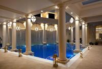 a large swimming pool in a building with columns at The Gainsborough Bath Spa - Small Luxury Hotels of the World in Bath