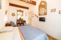 a bedroom with a bed and a mirror on the wall at Michelet in Collioure