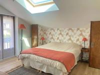 a bedroom with a large bed and a skylight at Manava Villa vue mer et Mont Saint Michel piscine intérieure in Saint-Jean-le-Thomas