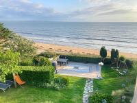 an overhead view of a backyard with a playground and the beach at Manava Villa vue mer et Mont Saint Michel piscine intérieure in Saint-Jean-le-Thomas