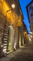 a stone building with an archway on a street at night at Albergo Sant&#39;Emidio in Ascoli Piceno