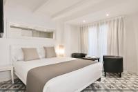 Postel nebo postele na pokoji v ubytování Uma Suites Sagrada Familia
