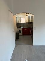 a kitchen with red cabinets and a white floor at Grand T2 climatisé a 5 min de la gare st-charles - vieux port in Marseille