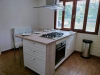 a kitchen with a stove and a counter top at Les Beaux Sapins 2 in Rochechouart
