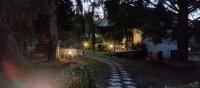 a garden at night with a stone path in front of a house at Les Beaux Sapins 2 in Rochechouart