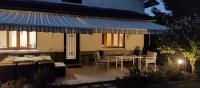 a patio with tables and chairs and a blue awning at Les Beaux Sapins 2 in Rochechouart