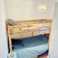 a bunk bed in the corner of a room at Winter Cocon in Mijoux