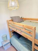 a wooden bunk bed in a bedroom with a lamp at Winter Cocon in Mijoux
