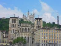 a group of buildings in front of a mountain at Les 24 colonnes in Lyon