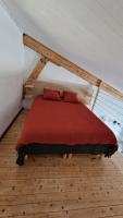 a bedroom with a red bed in a room at Studio Au Pied De La Sainte Victoire in Puyloubier