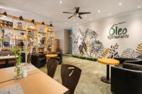 a restaurant with tables and chairs and a sign on the wall at Novelty Suites Hotel - Oviedo Mall in Medellín