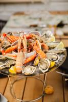 a plate of food with seafood on a table at Le Castel Cabourg hôtel & SPA- Restaurant La Calypso in Cabourg