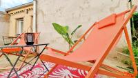 a pair of orange chairs and a table on a patio at Le Ptit Paradis - Calme - Wifi - Cour privée - Relax BNB in Mulhouse