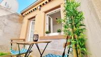 a small balcony with a table and a window at Le Ptit Paradis - Calme - Wifi - Cour privée - Relax BNB in Mulhouse