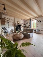 a living room with a couch and a table at Gîte les Pieds dans l&#39;eau bord de Sèvre, 10 min du Puy du Fo in Treize-Vents