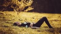 a woman laying on the grass in a field at Naéco Erdeven in Erdeven