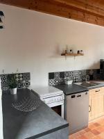 a kitchen with a sink and a counter top at Gîte les Pieds dans l&#39;eau bord de Sèvre, 10 min du Puy du Fo in Treize-Vents