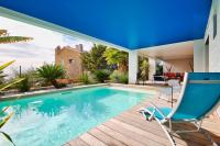 a house with a swimming pool and a blue chair at Prestigious villa with panoramic sea view in Bandol