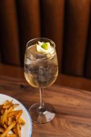 a drink in a glass next to a plate of fries at Hilton Orrington/Evanston in Evanston