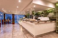 a restaurant with a counter and some plants at Hotel Riviera in Mar del Plata