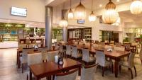 a restaurant with wooden tables and chairs and lights at Hotel Riviera in Mar del Plata