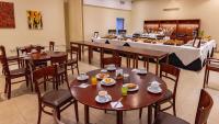 a restaurant with tables and chairs and a buffet at Hotel Riviera in Mar del Plata