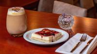 a piece of cake on a plate next to a drink at Hotel Riviera in Mar del Plata
