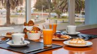 a table with food and two glasses of orange juice at Hotel Riviera in Mar del Plata