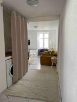 a hallway leading to a living room with a couch at Cocooning in Colmar