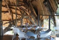a dining room with a table and white chairs at Bethel Lozana Guatape in Guatapé