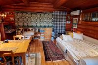 a bedroom with two beds and a table and chairs at Cozy Beach Cabin - close to city center in Pargas