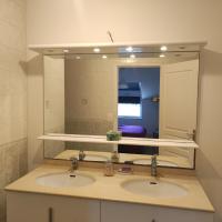 a bathroom with two sinks and a large mirror at le calme de la campagne bretonne, wifi, netflix, 4 lits, freebox revolution, draps, café, thé in Guer