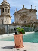 a potted plant sitting on a table in front of a building at Boutique Hotel OLOM - Only Adults recommended in Cádiz