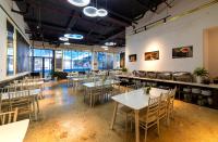 a dining room with tables and chairs and windows at Stillus Boutique Hotel Dalat in Da Lat