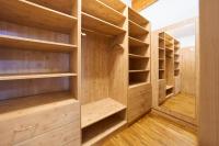 a walk in closet with wooden shelves at Alpina Holiday Living Apartments in Obertauern