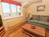 a living room with a couch and a table at The Beach House in Newquay