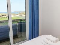 a mirror in a room with a bed and a balcony at The Beach House in Newquay