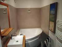 a bathroom with a white tub and a sink at VILLA KB&#39;HOME in Le Touquet-Paris-Plage